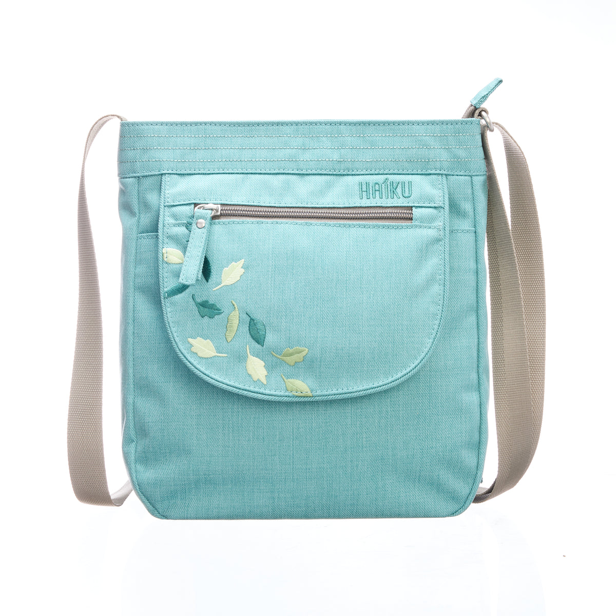 Light blue crossbody bag with floral embroidery and 'Haiku' branding on a white background