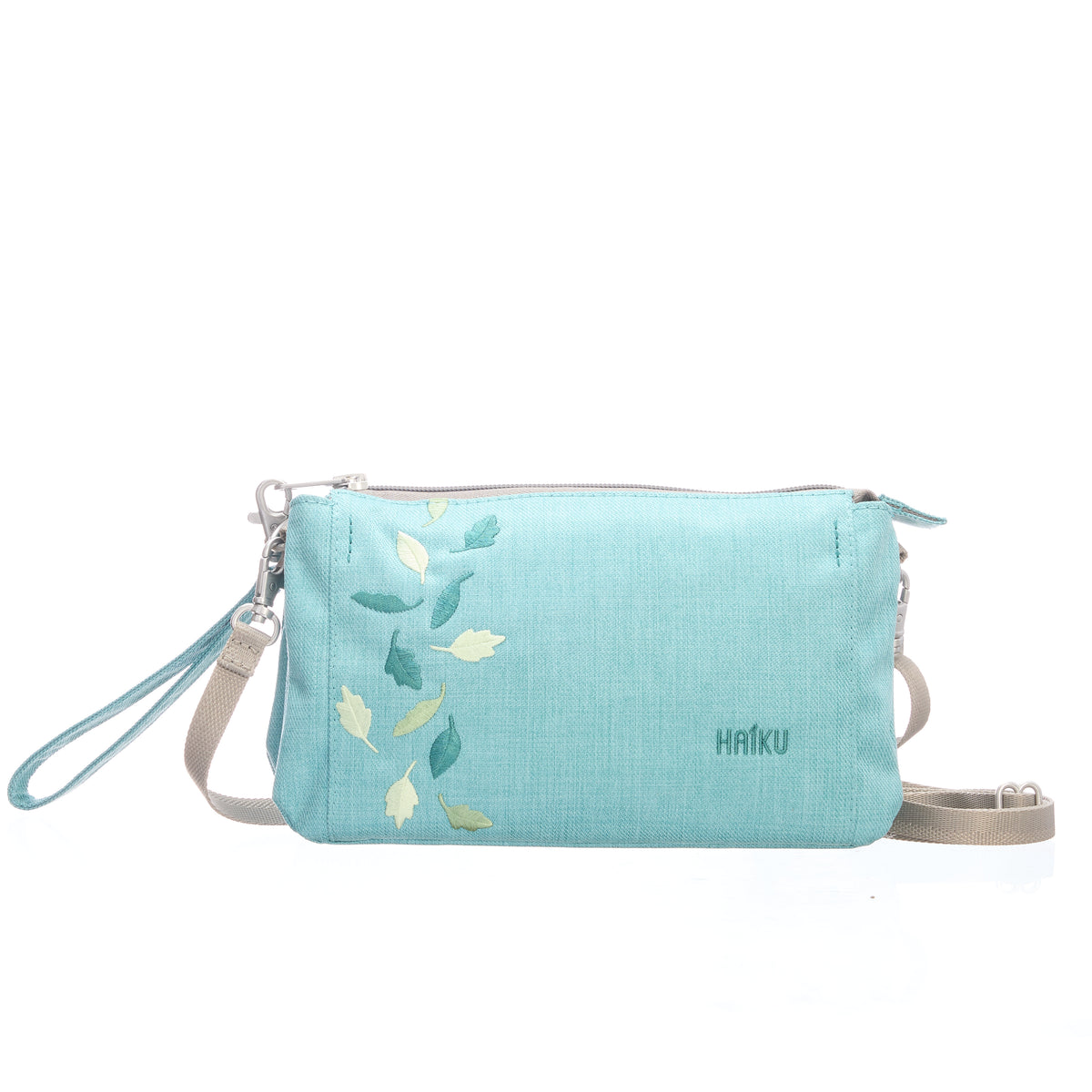 Light blue crossbody bag with floral design and 'HAIKU' branding on a white background