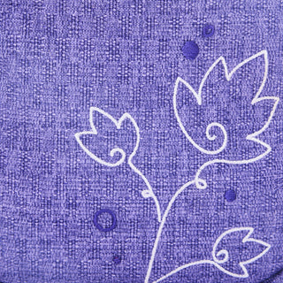White floral design on a textured purple fabric background