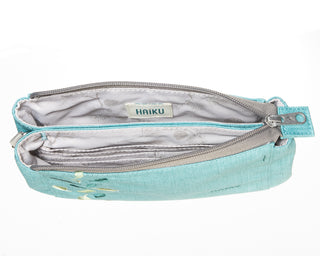 Wild Mint Stride Wristlet interior with leaf design on a white background