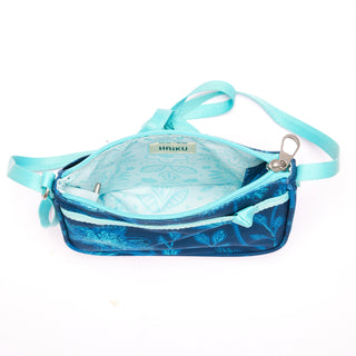 Blue Lark Crossbody bag with neon floral design interior on a white background 