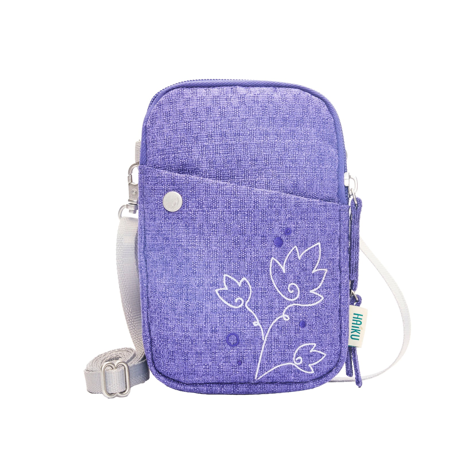 Purple crossbody bag with floral design on a white background