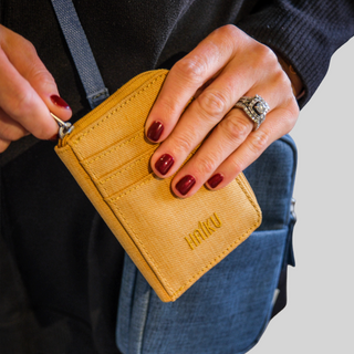 Honeycomb Sprout Wallet held by a hand model with a white background