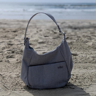 Stone Gray Amble Hobo Bag on a beach background